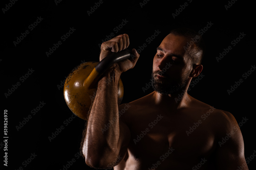 Close up portrait of guy training with the dumbbell