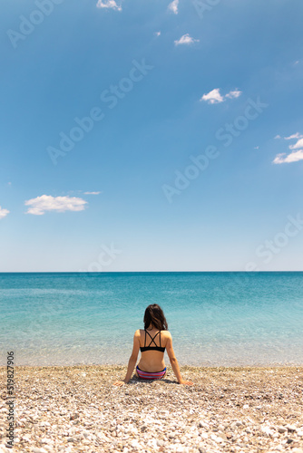 The girl is sunbathing on the beach
