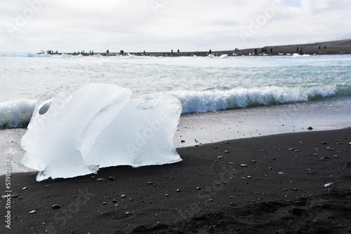 Piece of ice on the black sand