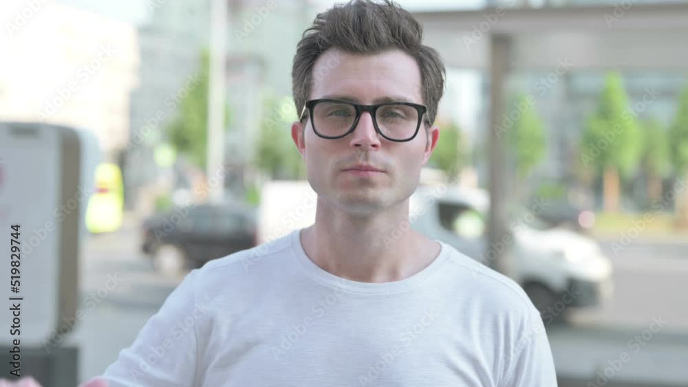 Thumbs Down By Young Man Standing Outdoor