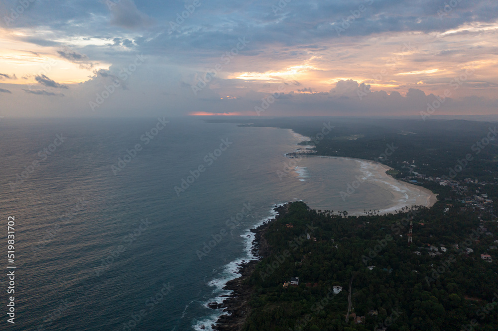 The beach and the ocean during sunset. Dickwella Beach, Sri Lanka.