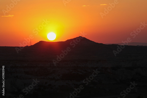 beautiful orange sky at sunset on mountains in goreme, cappadocia