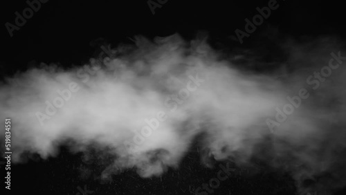 Aggressive pressurized steam flows from left to right on black background photo