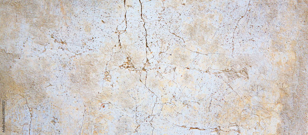 white and brown rough grained stone or concrete stucco wall, texture background