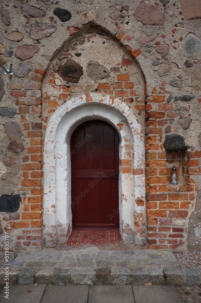 Entrance to Church of Assumption of the Blessed Virgin Mary. Chwarstno (village in Lobez County), Poland.