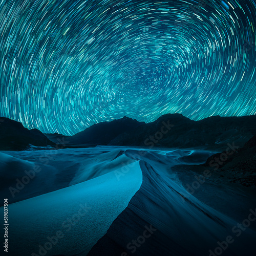 Beautiful blue night desert and dune on star trail background.