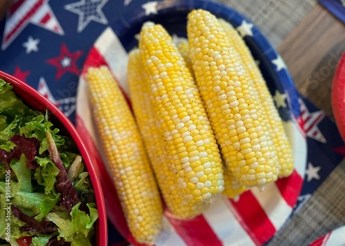 Canvastavla Fresh, shucked corn on the cob ready to eat with red, white, and blue decor