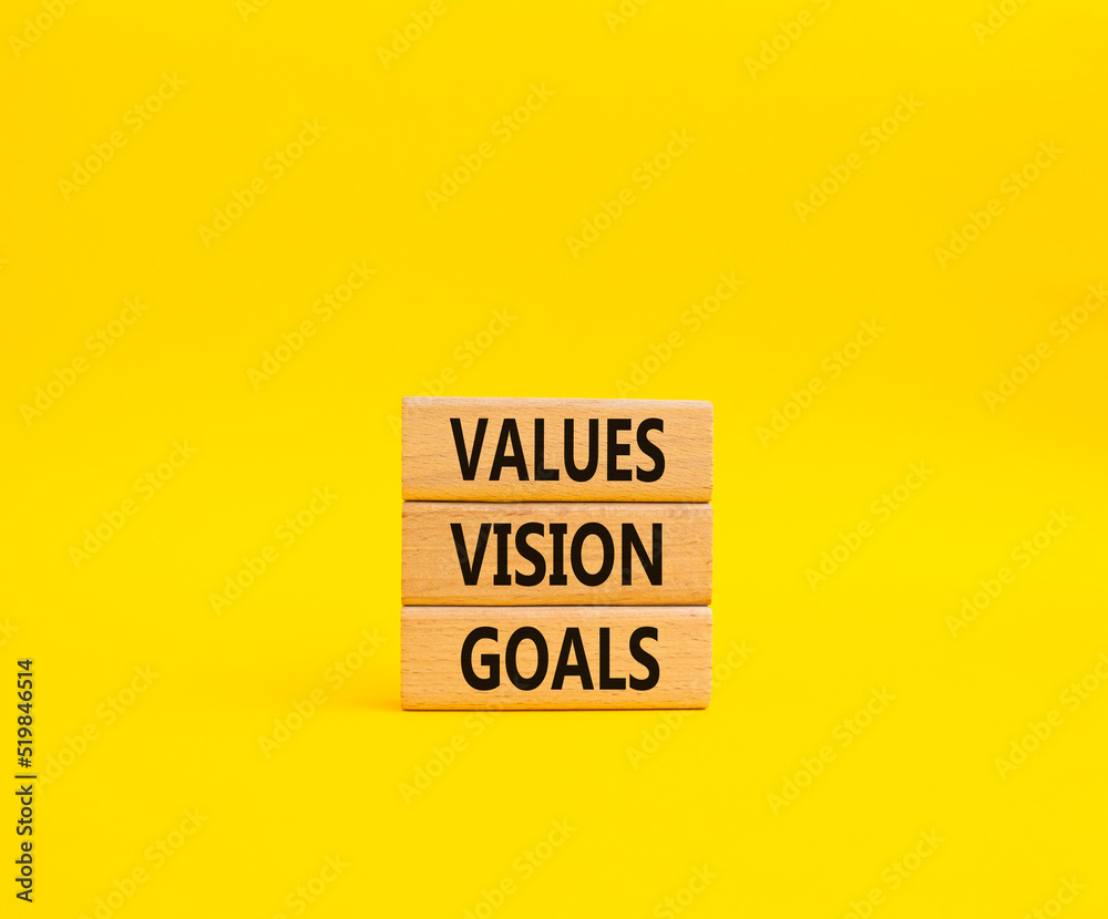 Values Vision Goals symbol. Concept words Values Vision Goals on wooden blocks. Beautiful yellow background. Business and Values Vision Goals concept. Copy space. Values Vision Goals symbol. Concept words Values Vision Goals on wooden blocks. Beautiful yellow background. Business and Values Vision Goals concept. Copy space.