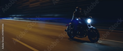 Photography Biker riding his custom built cafe racer motorcycle through city at night