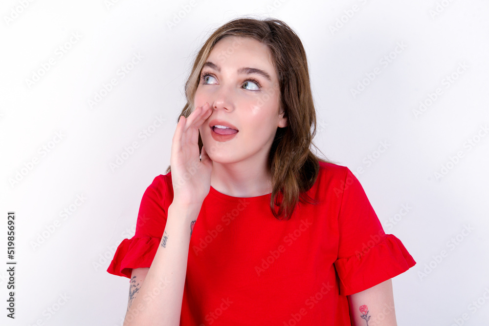 young caucasian woman wearing red T-shirt over white background hear incredible private news impressed scream share young caucasian woman wearing red T-shirt over white background hear incredible private news impressed scream share