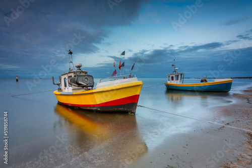 Beautiful sunset with fishing boats at the beach of Baltic Sea in Sopot, Poland