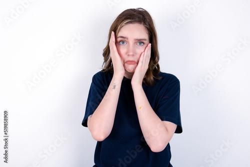 young caucasian woman wearing black T-shirt over white background Tired hands covering face, depression and sadness, upset and irritated for problem