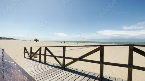 (Slow-Mo) Sanlucar de Barrameda beach in Spain. This beach is formed by water from the mouth of the Gualdalquivir River and the Atlantic Ocean, with the 'Coto Doñana' National Park in front. photo