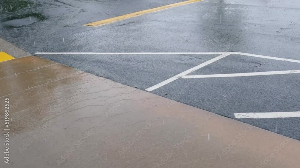 Rain in a parking lot yellow and white lines and water puddles Rain in a parking lot yellow and white lines and water puddles