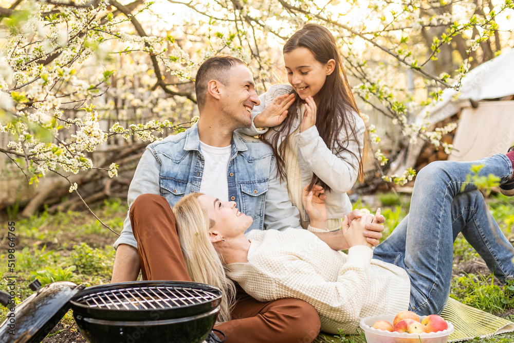 Happy family having barbecue with modern grill outdoors Happy family having barbecue with modern grill outdoors