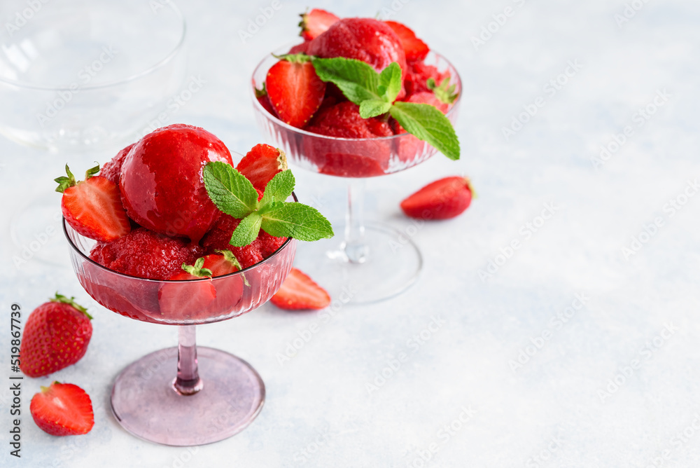 Strawberry sorbet with mint and fresh berries in glass bowls. Fruit berry summer ice cream. Vegetarian healthy dessert. Selective focus Strawberry sorbet with mint and fresh berries in glass bowls. Fruit berry summer ice cream. Vegetarian healthy dessert. Selective focus