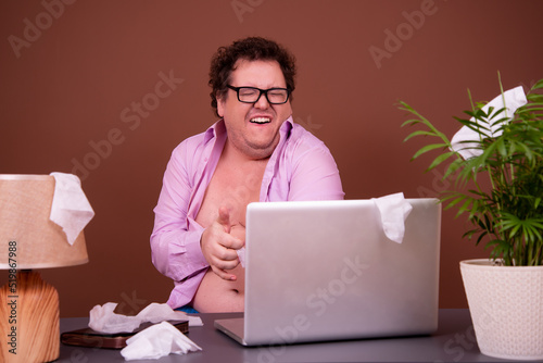 Fotografie Funny fat man watching adult video.