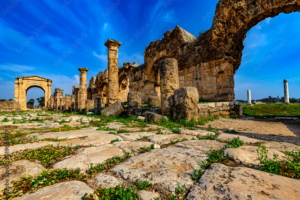 Lebanon. Ancient Tyre (UNESCO World Heritage Site). Paved Roman road and the triumphal arch of Hadrian in the background