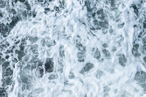 Sea water texture with splashes and foam, top view