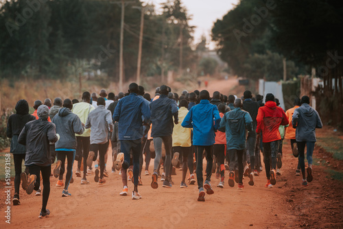 Group training in Kenya. A large group of Kenyan runners are preparing for the race. Endurance and marathon professional runners run on the red soil of Iten, home of champions. Africa, Kenya
