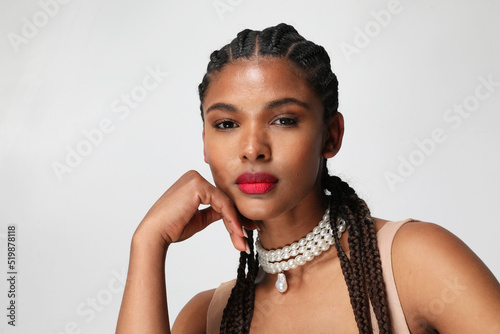 Fotobehang Close-up of African American woman with long dark braids, posing indoor