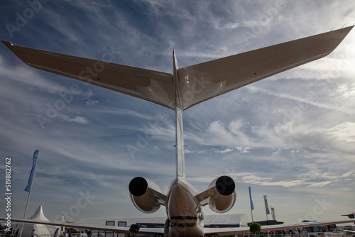 Tail and Engines wide angle view of a private jet parked on the ground of a airport  