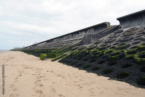 the beach and seawall south of blackpool constructed of concrete honeycomb type structures with steps