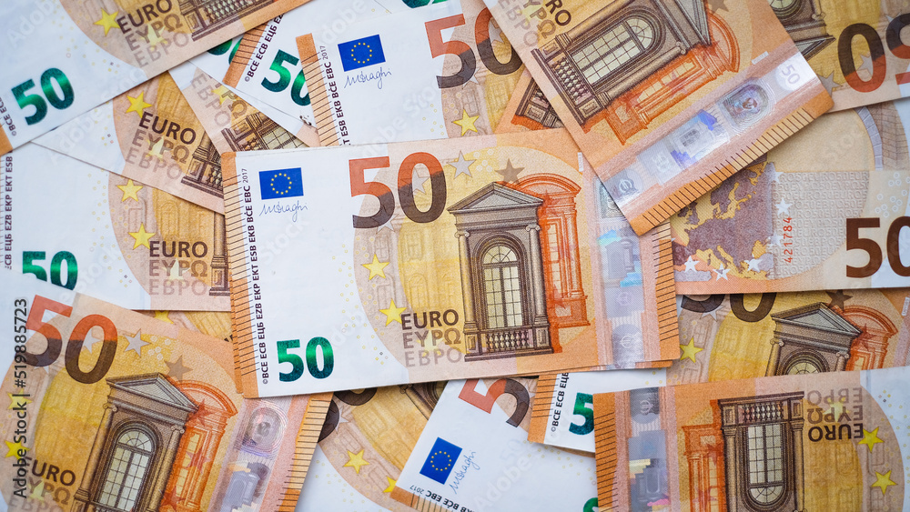 The background consists of many euro banknotes of different denominations. Finance and business concept