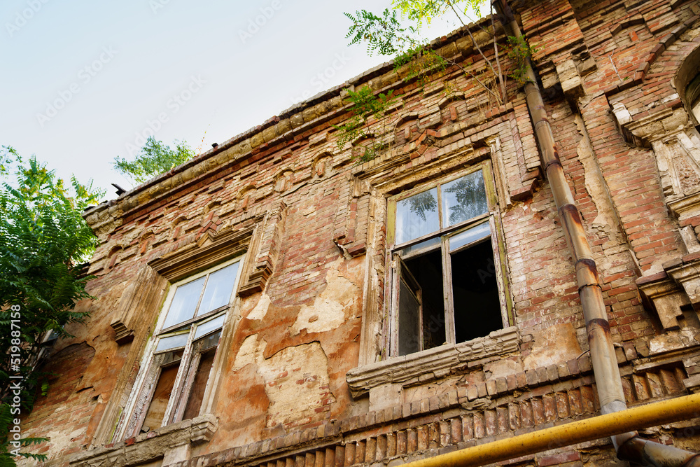 an old ruined building against the sky. broken glass in the windows. an old ruined building against the sky. broken glass in the windows.