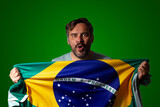 Male soccer fan holding a Brazilian flag. Background with lettering 