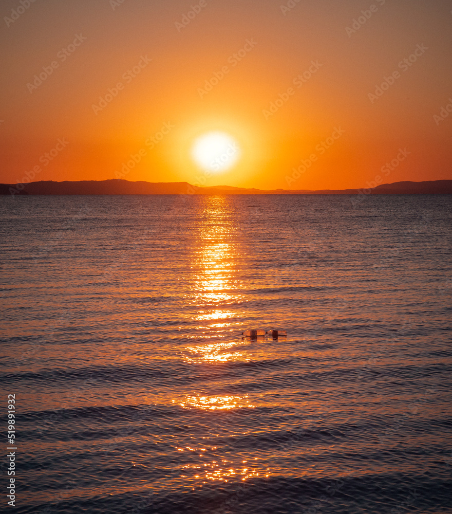 sunrise at the sea with plastic bottles floating sunrise at the sea with plastic bottles floating