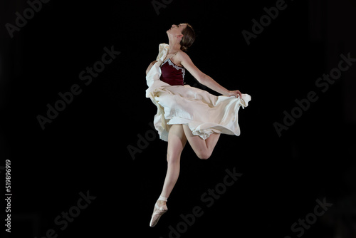 Ballet dancer on a black background. The dancer in a dance. Ballet pose. Dancer in a jump