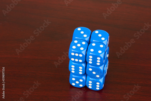 6-sided dice stacked isolated on mahagony background  photo