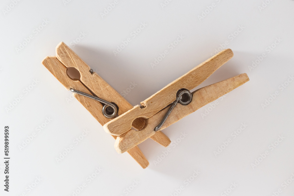 Two wooden clothespins on a white background Two wooden clothespins on a white background
