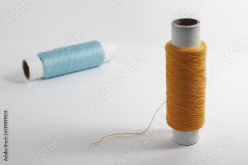 Two spools of thread