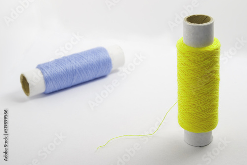 Two spools of thread