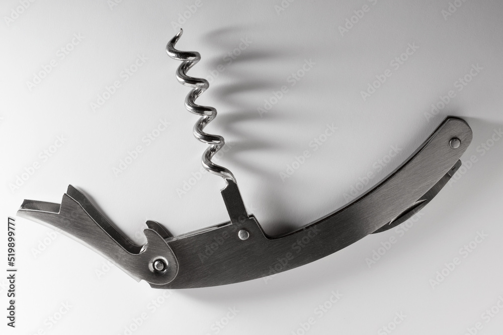 Spiral wine corkscrew on the white surface Spiral wine corkscrew on the white surface