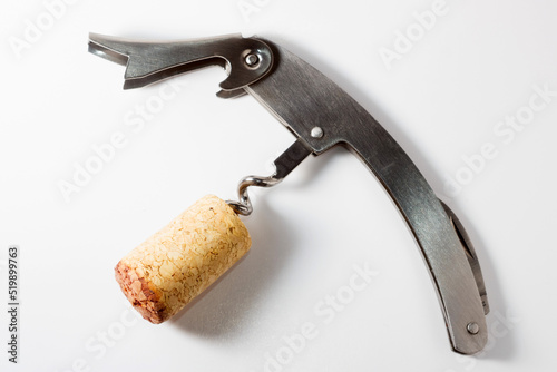 Corkscrew with wine stopper. Cork stoppers with traces of red wine
