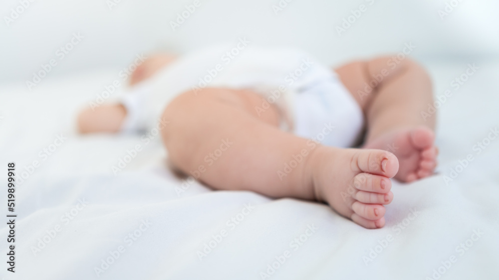 Newborn chubby foots over white background. Close up new born baby body part. Newborn chubby foots over white background. Close up new born baby body part.