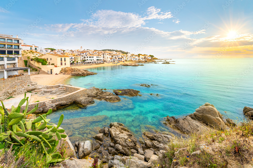 The rocky coast, sandy beach and whitewashed fishing village of Calella de Palafrugell, Spain on the Costa Brava Spanish coast.	