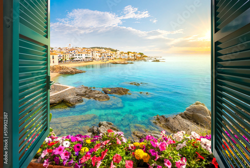 Print op canvas View through an open window with shutters of the whitewashed Costa Brava village of Calella de Palafrugell, Spain, as the sun sets on the Catalonian coast of Southern Spain