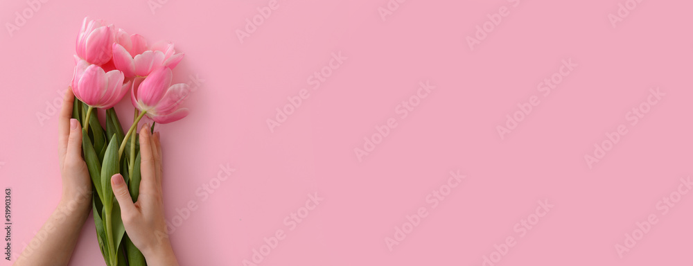 Female hands with beautiful flowers on pink background with space for text Female hands with beautiful flowers on pink background with space for text