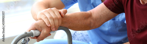Elderly man with caregiver ...