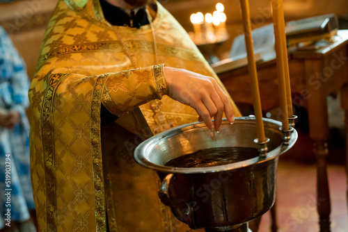 Foto close-up of a priest's hands with a basin of water