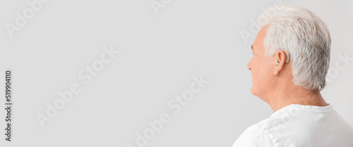 Mature man with hearing aid...