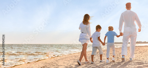 Young family walking on sea...