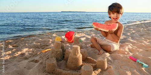 Little boy eating juicy wat...