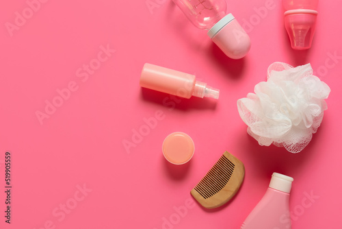 Different bath accessories for baby on pink background