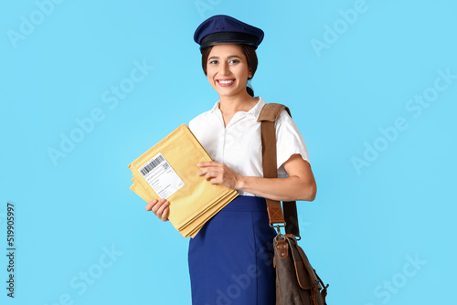 Young postwoman with letter...