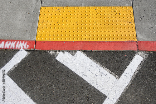 Canvas-taulu Freshly painted white crosswalk marking leading to a yellow painted ADA sidewalk